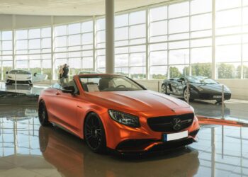 red chevrolet camaro parked in front of building