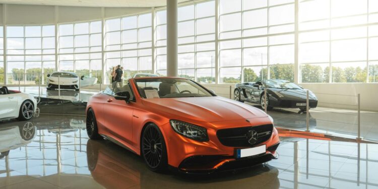red chevrolet camaro parked in front of building